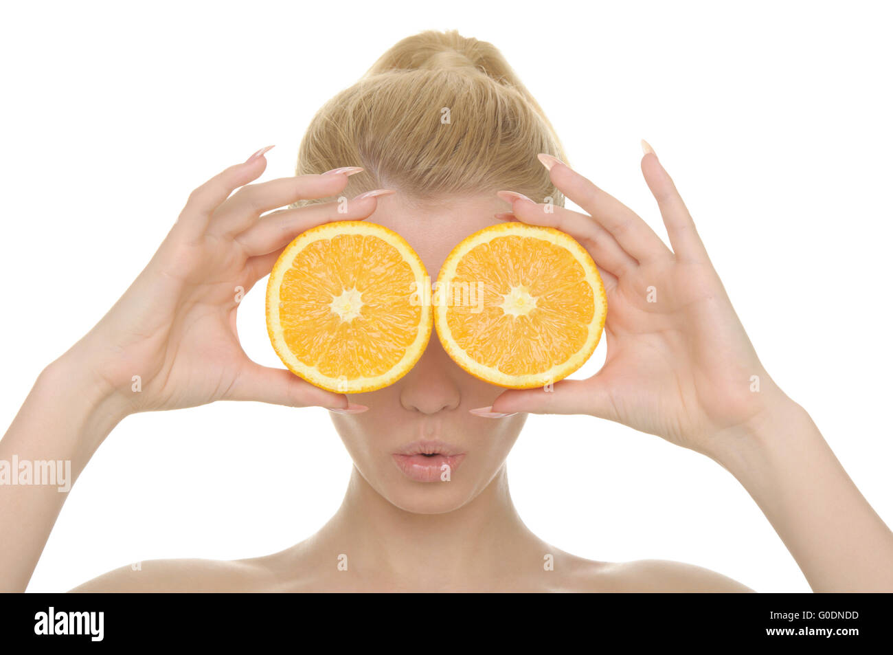 Young woman holds halves of oranges before eyes Stock Photo Alamy