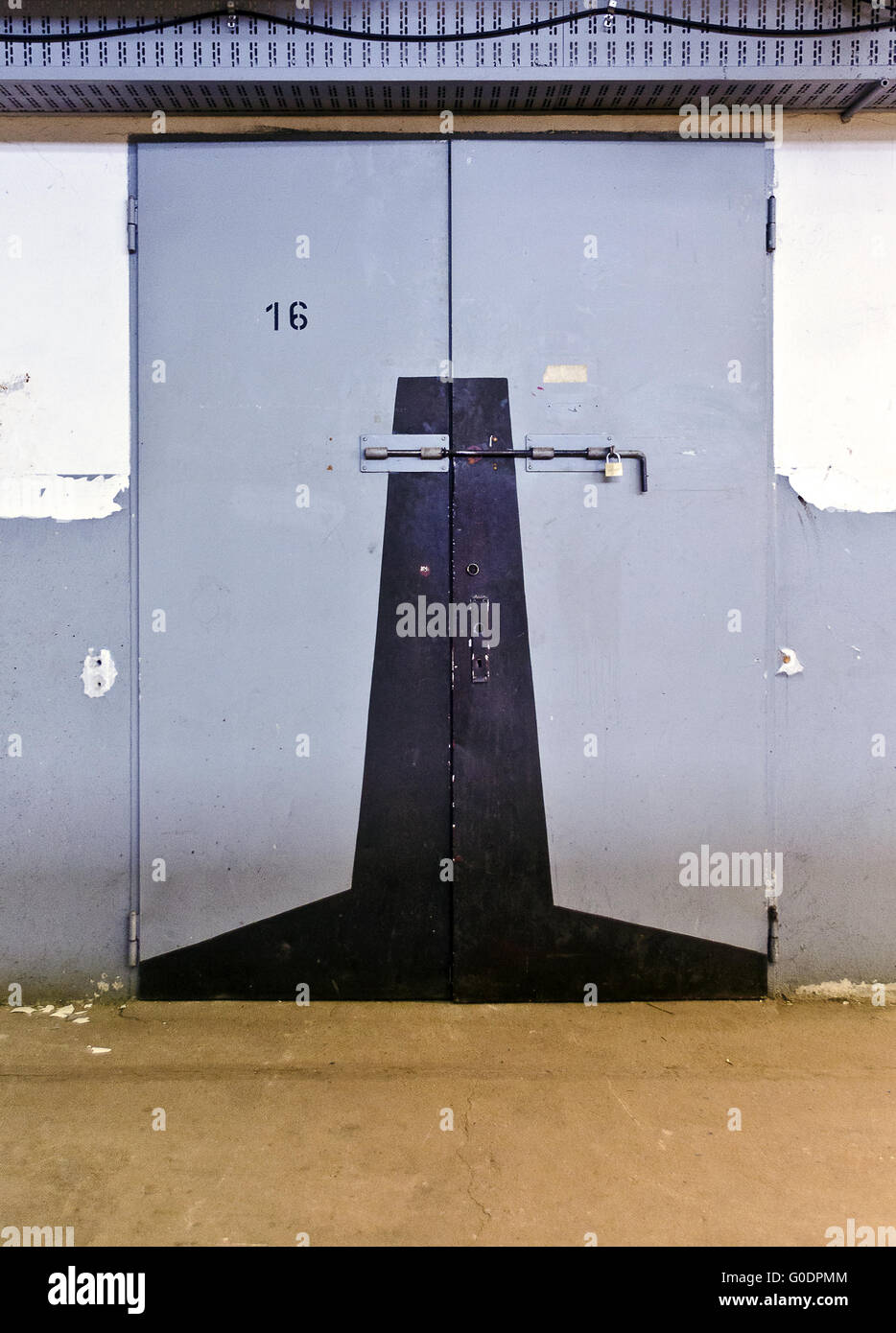 metallic door with the number sixteen and locked b Stock Photo