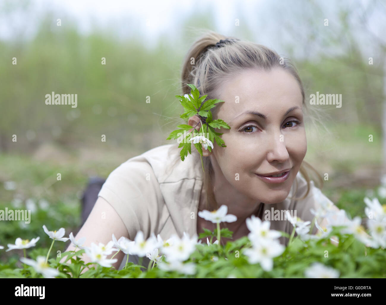 woman in the field of blossoming snowdrops in the Stock Photo
