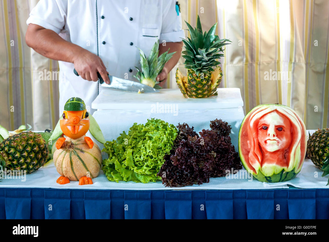 table with fruit carvings and partial view of a co Stock Photo