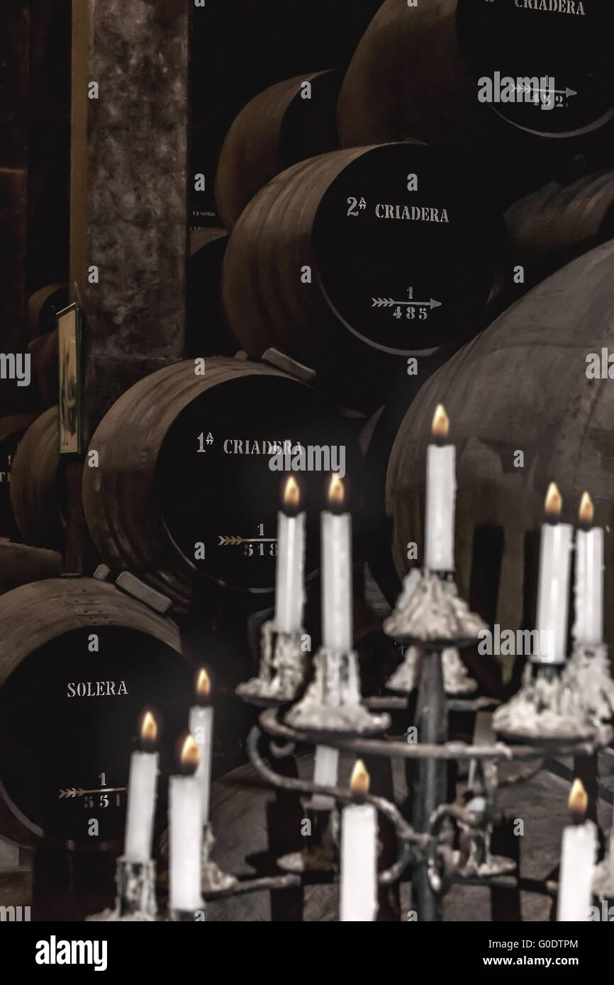 Stacked sherry barrels of a Solera with candlestic Stock Photo