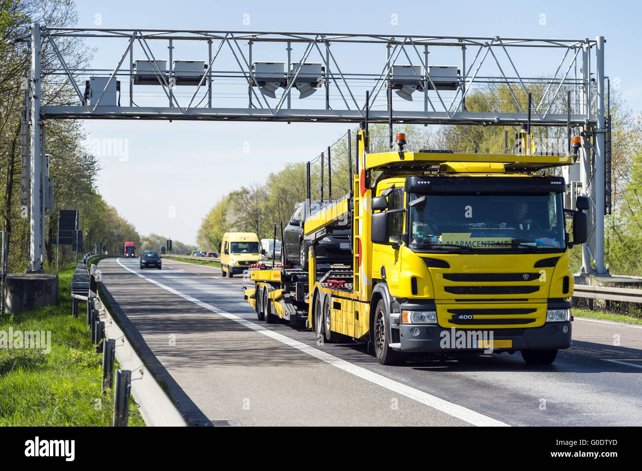 Yellow breakdown vehicle on the highway with a tol Stock Photo