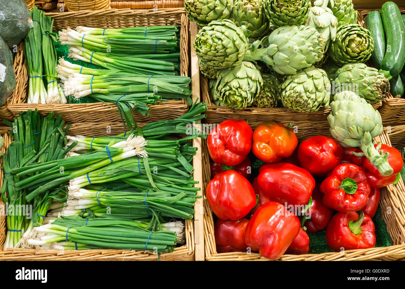 Leek, peppers and artichokes for sale at a market Stock Photo