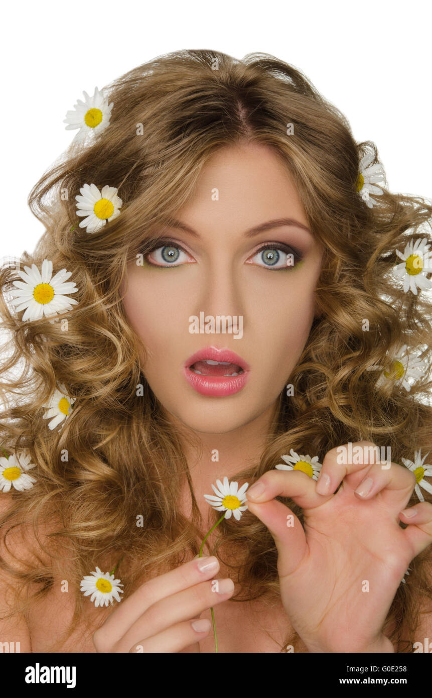 Surprised beautiful woman with daisies in hair Stock Photo