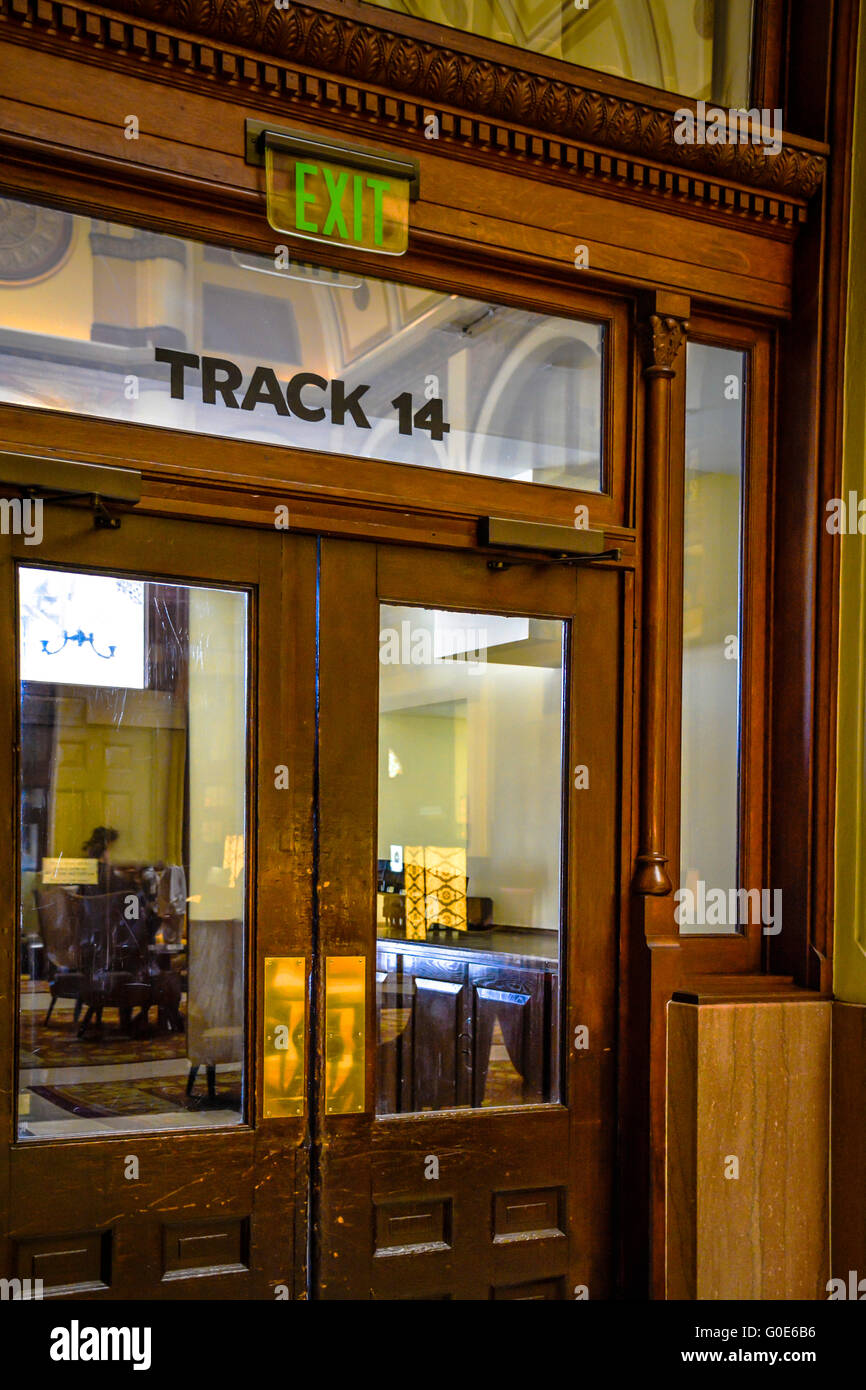 Interior of a vintage train station's wooden doors leading out to TRACK ...