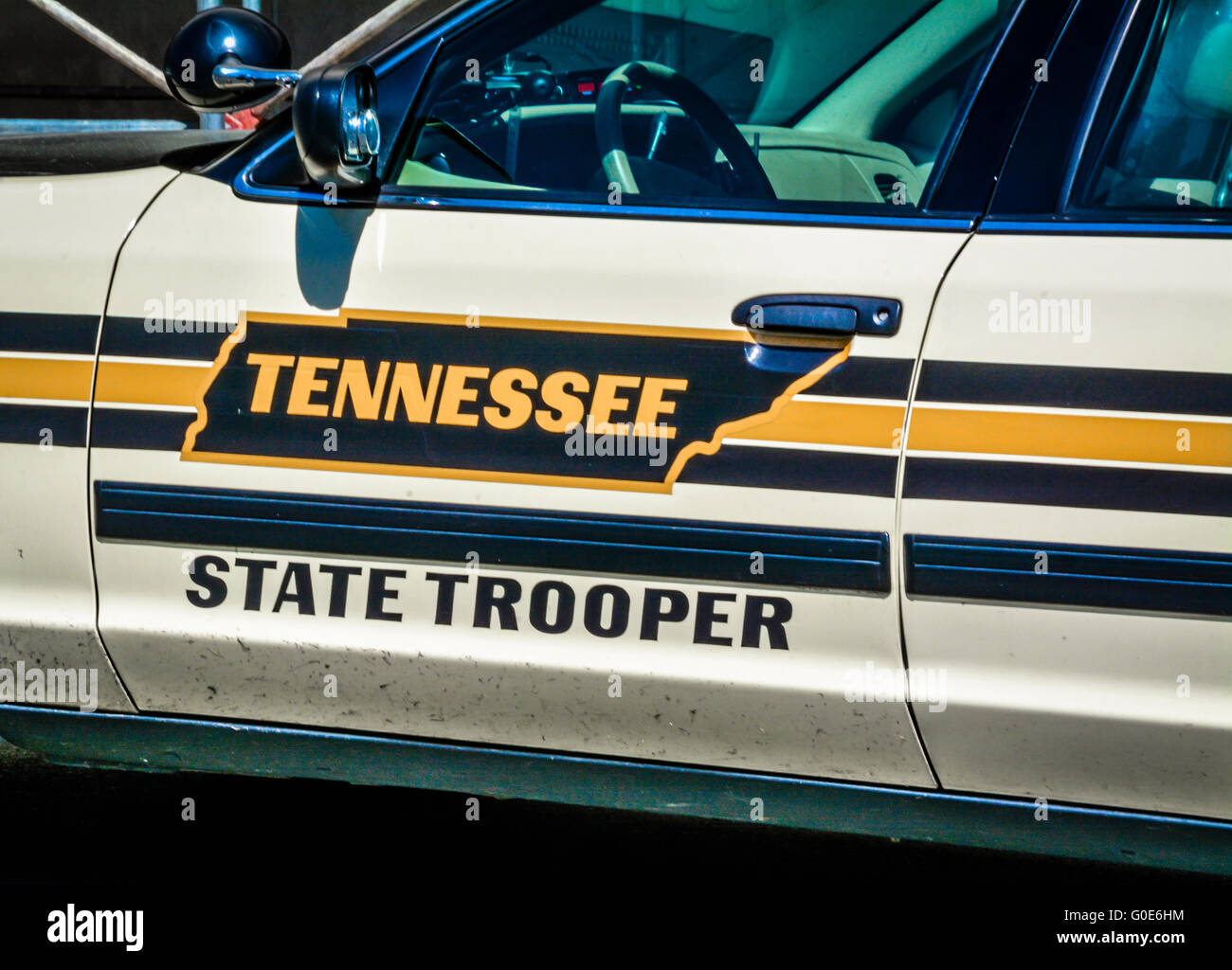 Cropped close view of Tennessee State Trooper patrol car door with it's state map outline graphic art in yellow and black graphic design Stock Photo