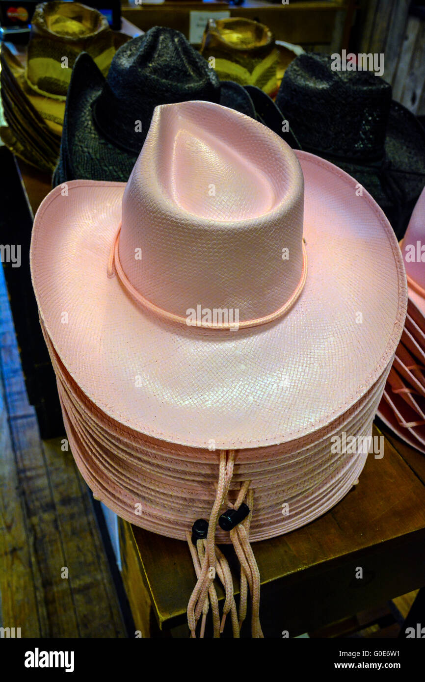 A Stack Of Pink Straw Cowboy Hats Sits On A Display Table Amongst Hundreds Of Cowboy Boots In The Nashville Cowboy Store Tn Stock Photo Alamy