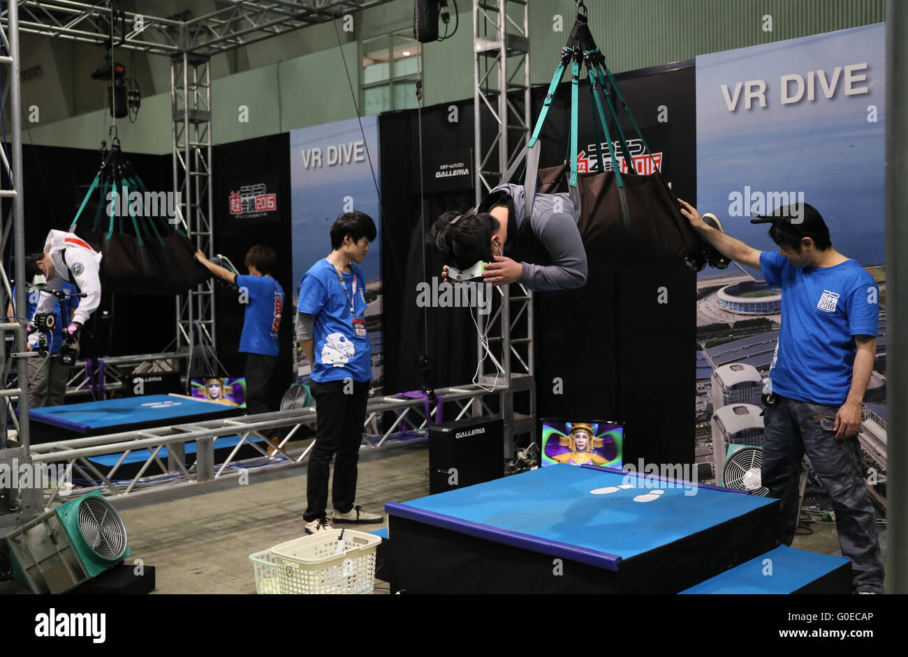 Chiba, Japan. 30th Apr, 2016. A visitor, hanged in the air by wire, enjoys virtual sky diving with headmount during the Niconico Chokaigi in Chiba on Saturday, April 30, 2016. Some 150,000 visitors enjoyed over 100 booths including games, hobbies, sports, politics as well as Japan's sub cultures at the two-day offline meeting sponsored by Japan's video sharing website "Niconico Douga". © Yoshio Tsunoda/AFLO/Alamy Live News Stock Photo