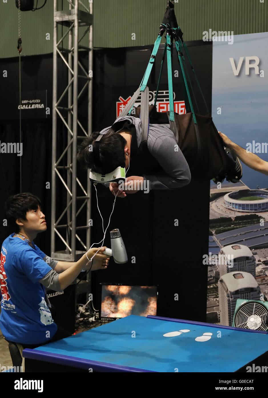 Chiba, Japan. 30th Apr, 2016. A visitor, hanged in the air by wire, enjoys virtual sky diving with headmount during the Niconico Chokaigi in Chiba on Saturday, April 30, 2016. Some 150,000 visitors enjoyed over 100 booths including games, hobbies, sports, politics as well as Japan's sub cultures at the two-day offline meeting sponsored by Japan's video sharing website "Niconico Douga". © Yoshio Tsunoda/AFLO/Alamy Live News Stock Photo