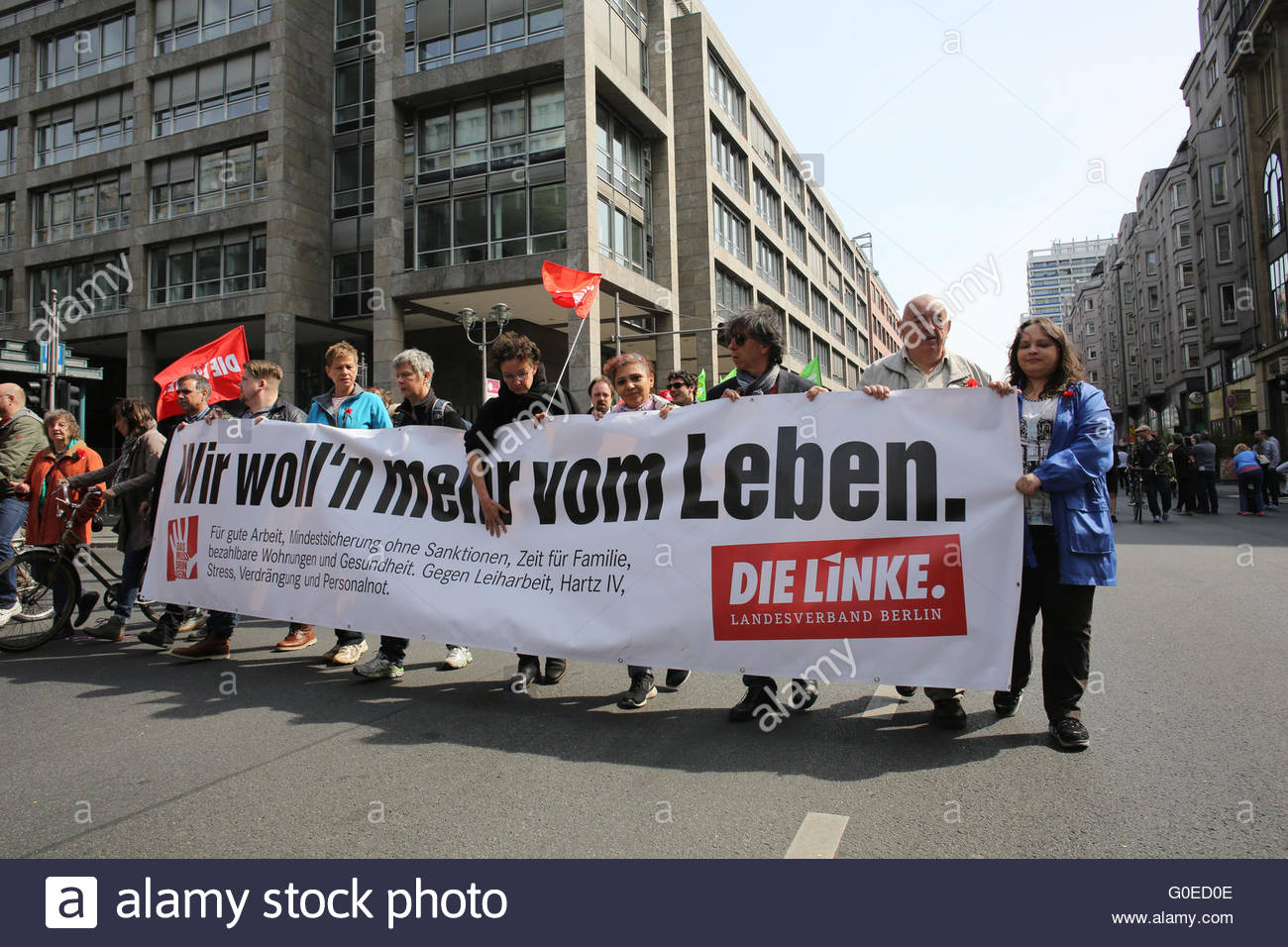 Berlin, Germany. 01st May, 2016. A group of participants in a march in Berlin hold a banner with the words the Linke on it as they proceed to the Brandenburg Gate. Credit:  reallifephotos/Alamy Live News Stock Photo