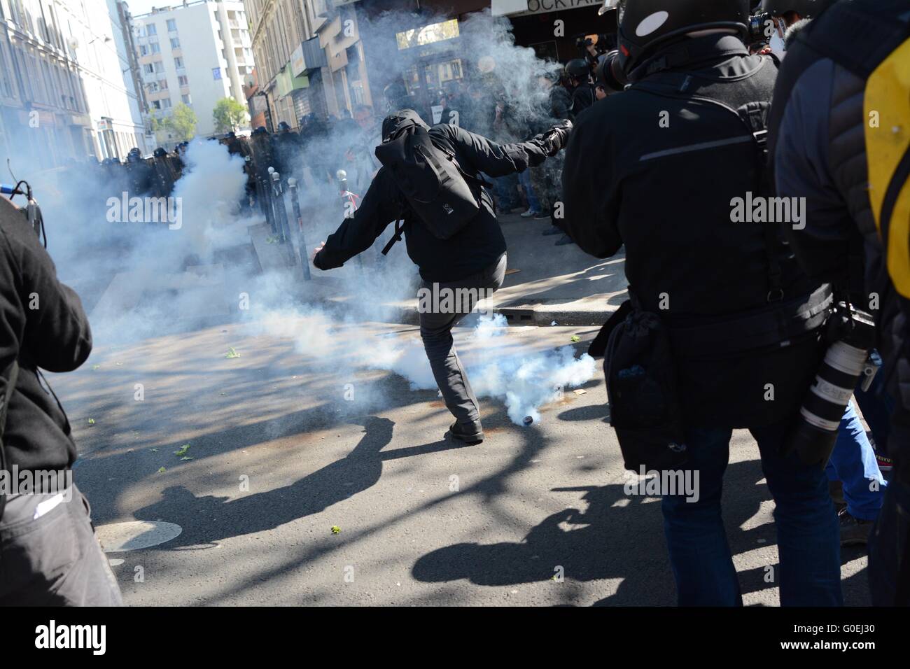 Paris, France. 1 May 2016. Protester kicks a teargas cannister away as labour law protest turns violent Credit: Marc Ward/Alamy Live News Stock Photo