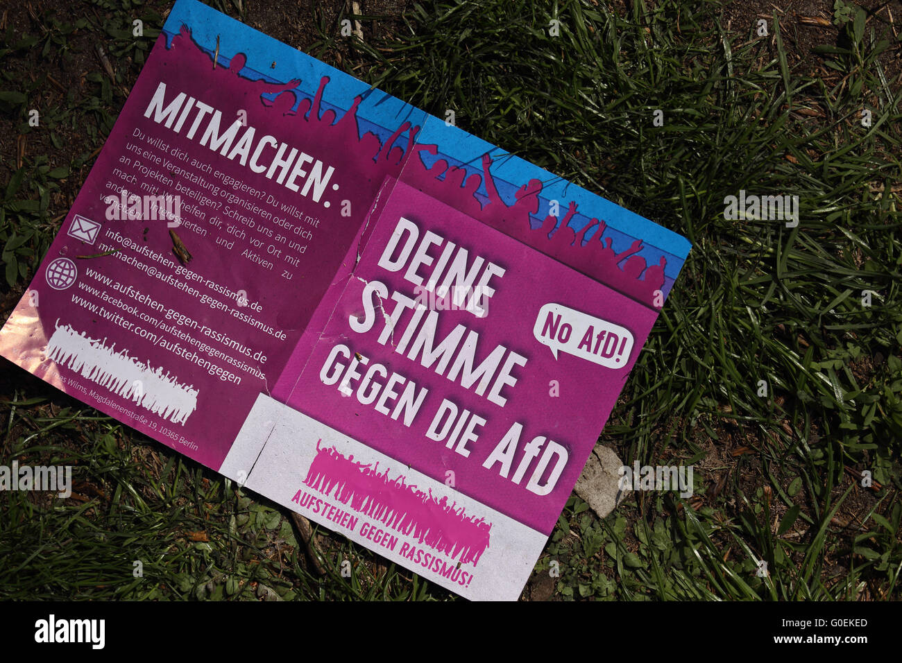 Leaflet in German against the AfD party lying on the grass. Stock Photo