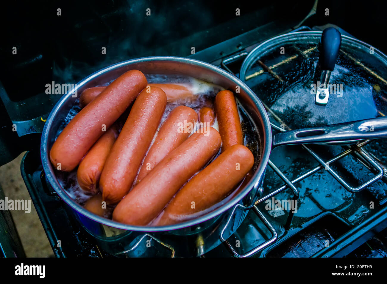 cooking breakfast on a camping stove Stock Photo Alamy