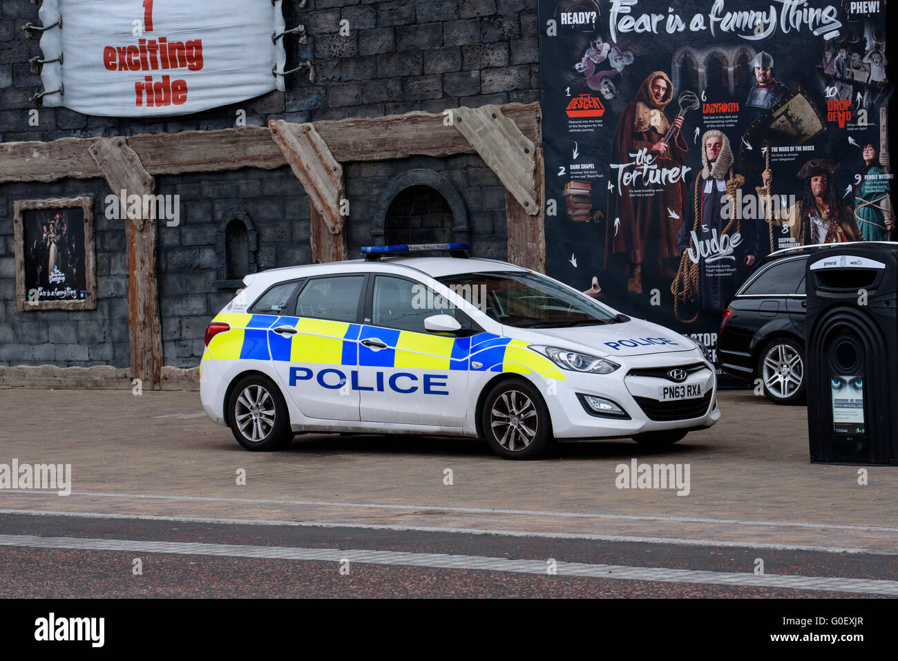 Police patrol car outside the Tower Dungeon tourist attraction on the promenade in Blackpool, Lancashire, UK Stock Photo