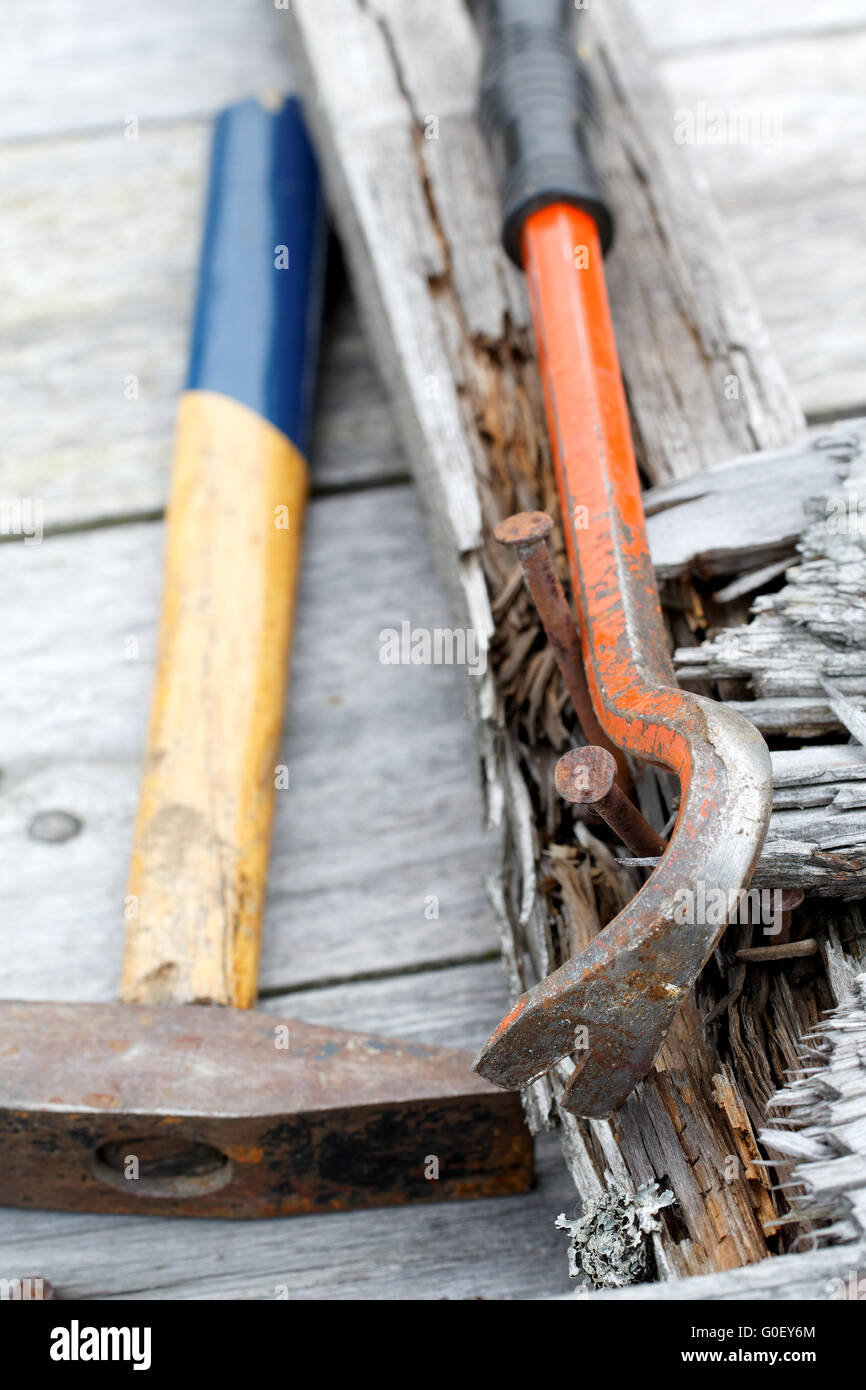 claw hammer and rusty nails on the old boards Stock Photo