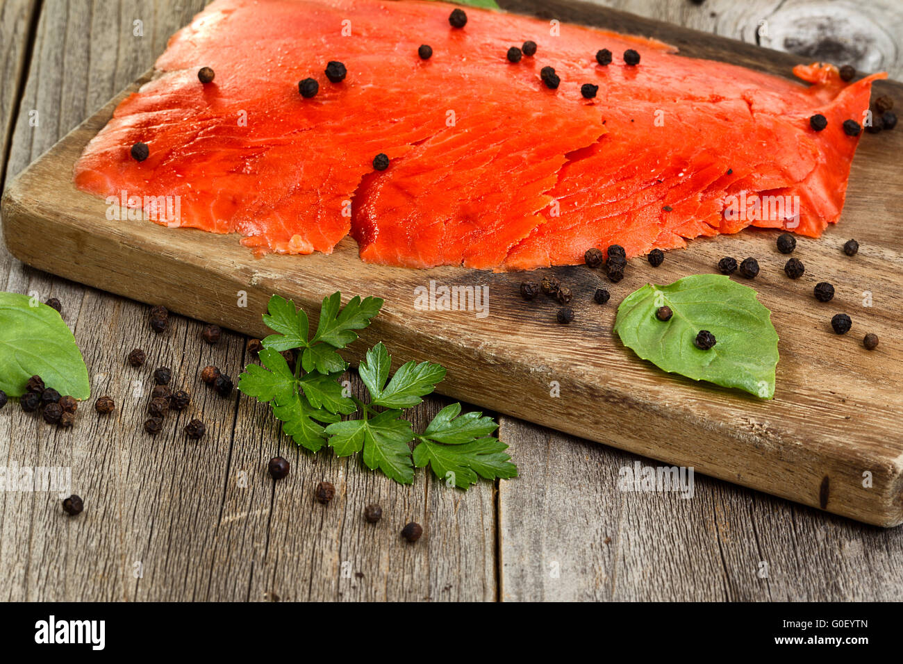 Close of cold smoked salmon on wooden server ready to eat Stock Photo
