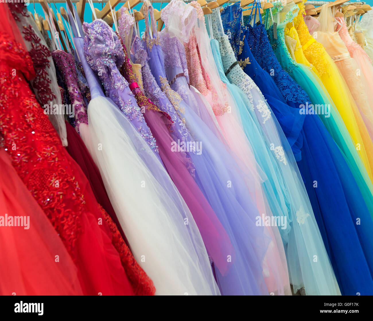 ladies evening dresses of different colors at shop Stock Photo