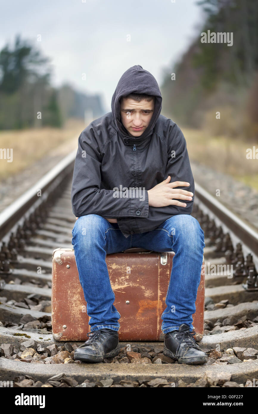 Teenage boy with a suitcase on the railway Stock Photo Alamy