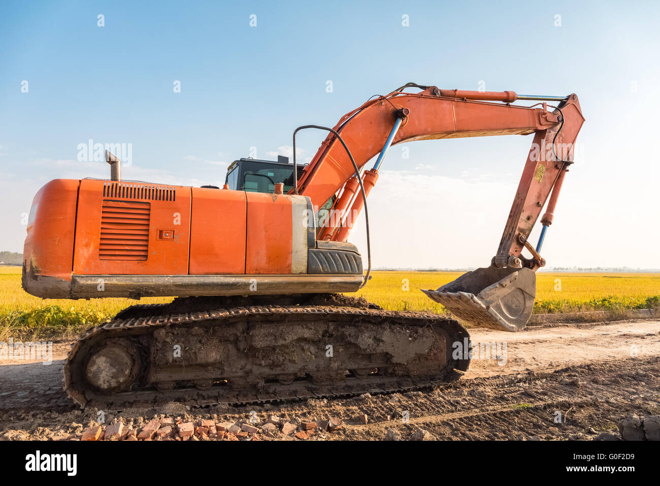 excavator on the country road Stock Photo