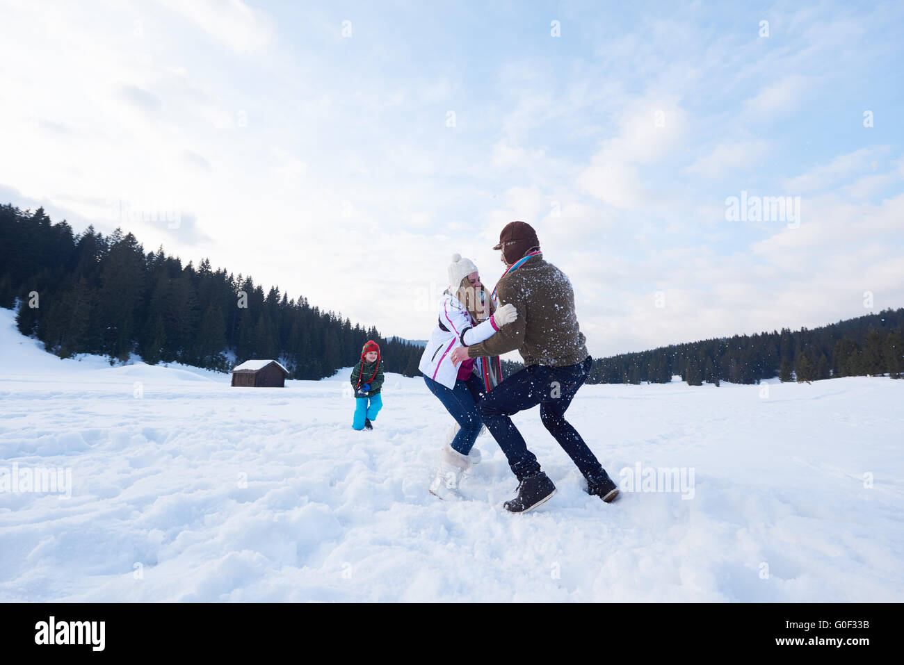 happy family playing together in snow at winter Stock Photo - Alamy