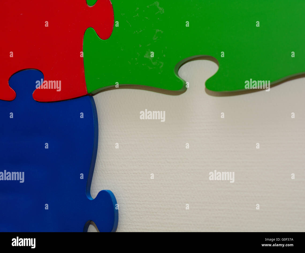 three giant puzzle pieces with intense colors Stock Photo