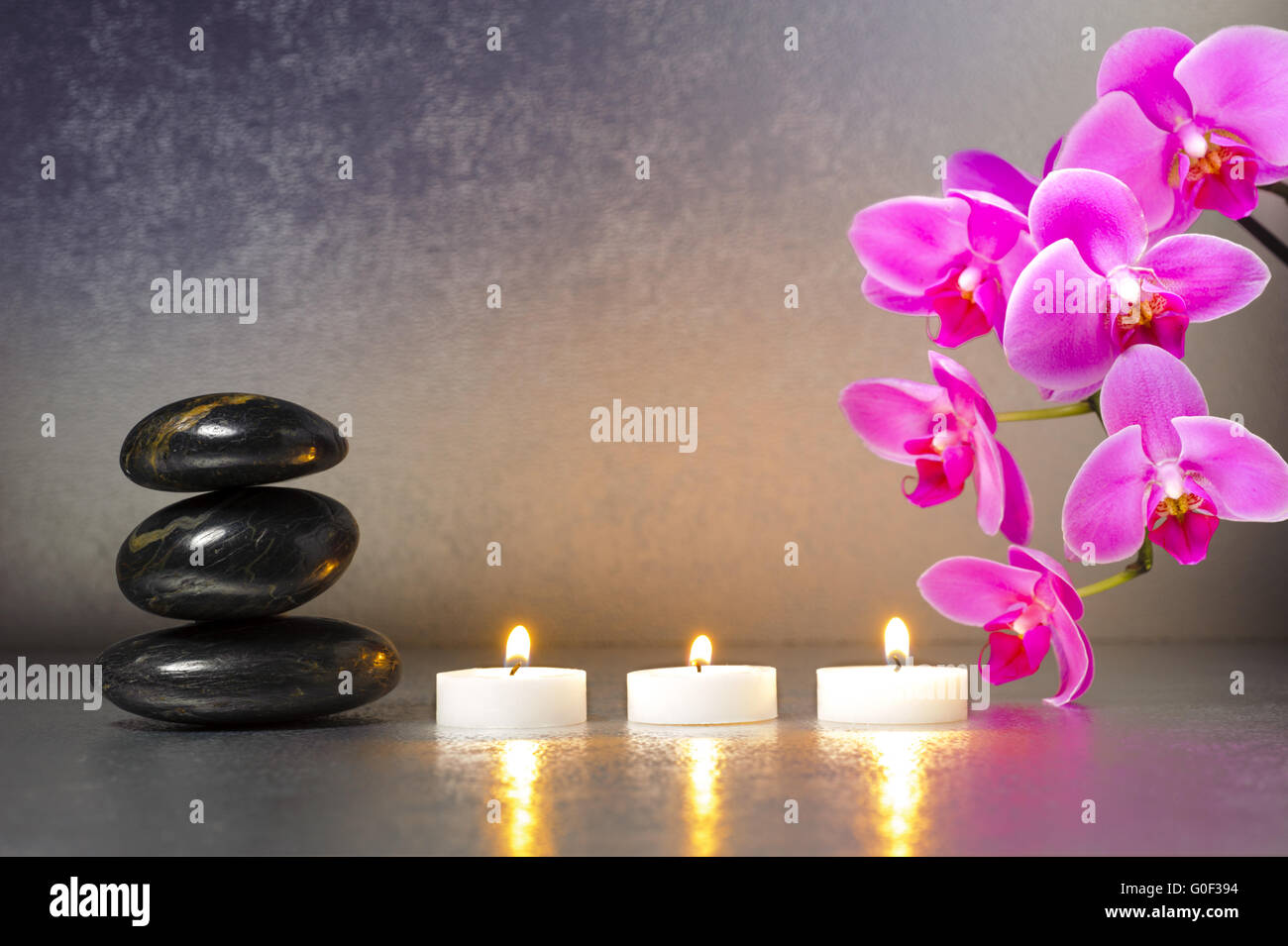Japanese ZEN garden with stacked stones and orchid flower Stock Photo