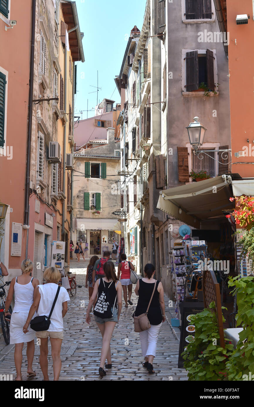 tourists on a tour through the old streets of Rovinj in Croatia Stock Photo