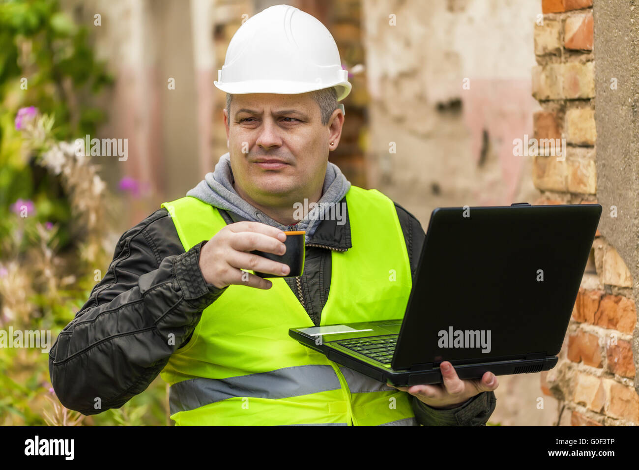 Engineer Tea Construction Engineer working with PC and drinking tea Stock Photo - Alamy