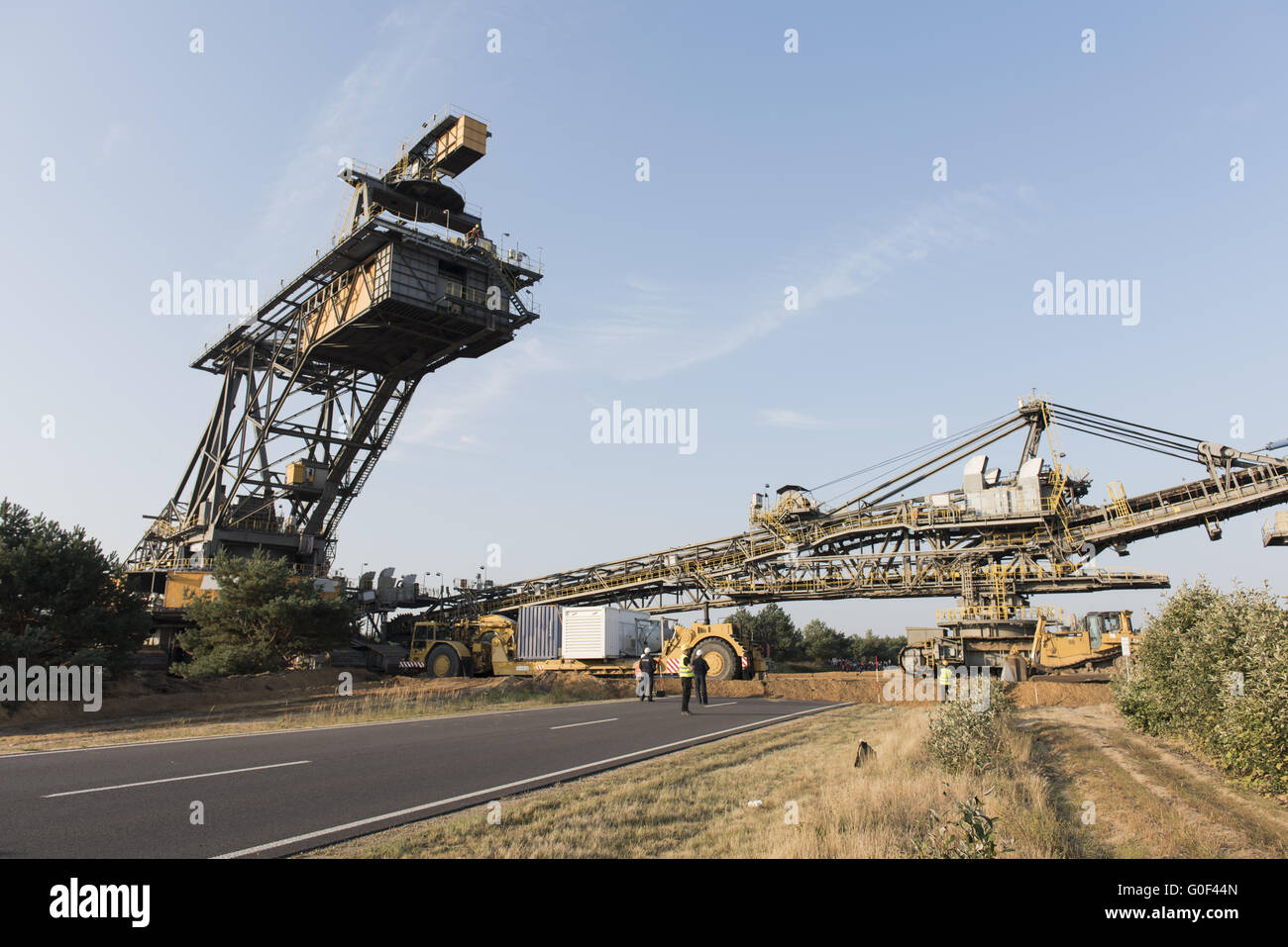 open cast mining tripper car cross a highway Stock Photo