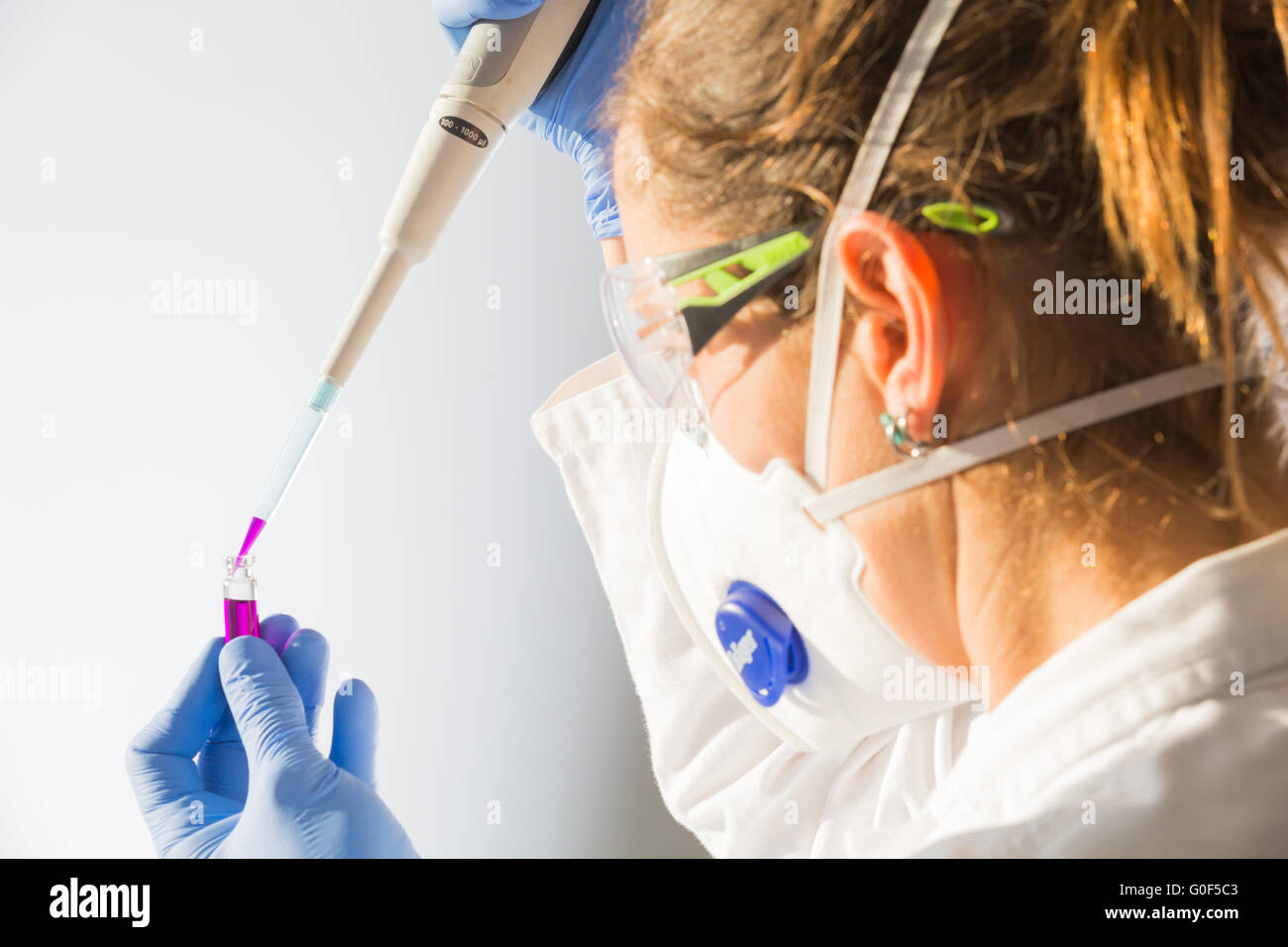 A scientist in a lab with pipette Stock Photo