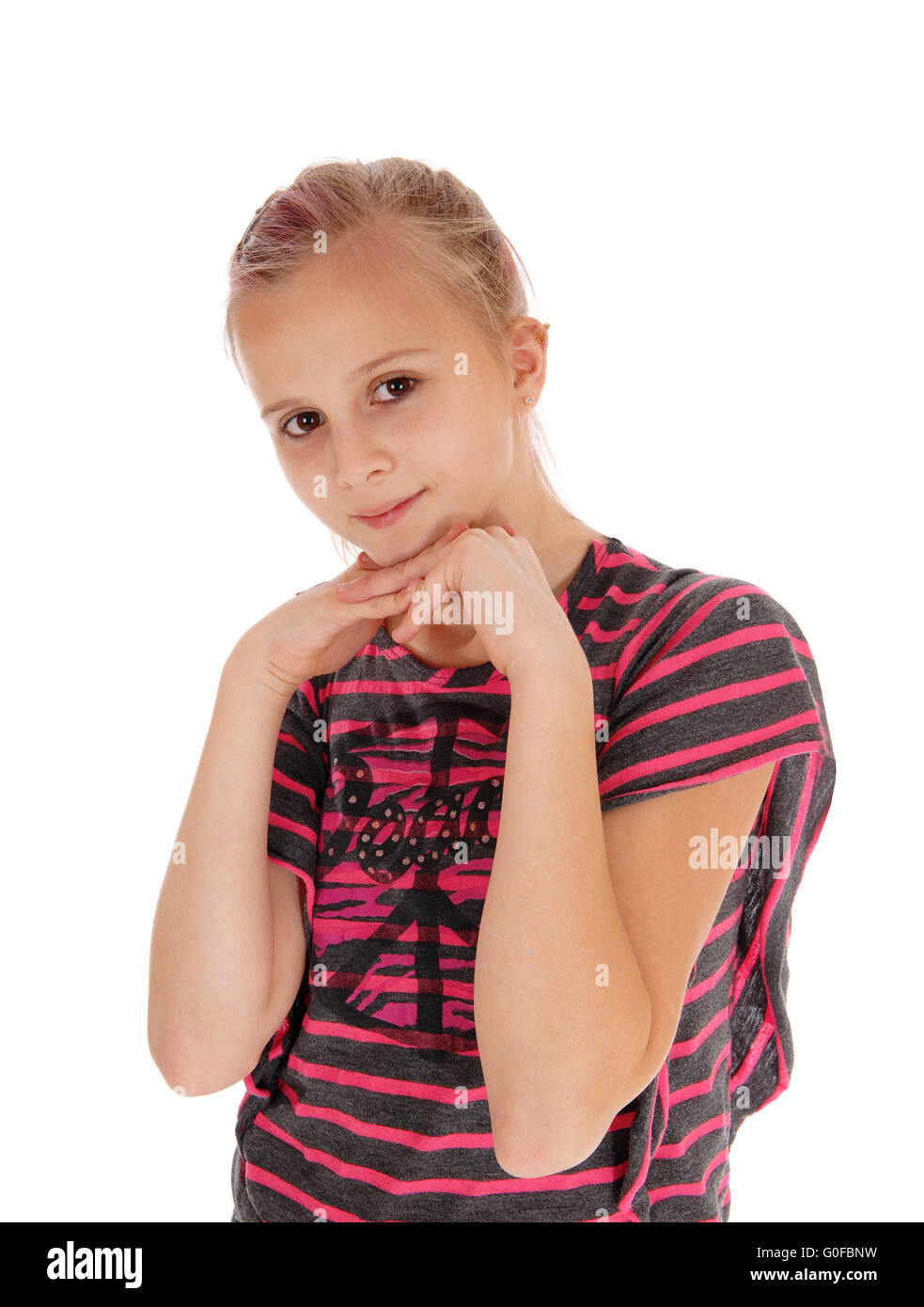 Young girl with hands under chin. Stock Photo