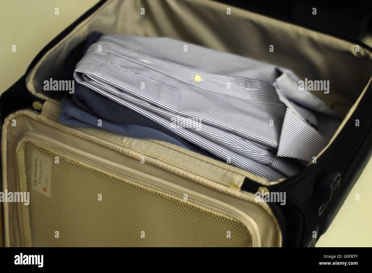 Packing the suitcase for a business trip Stock Photo