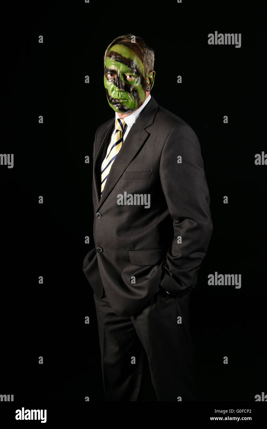 businessman with jungle camouflage paint Stock Photo