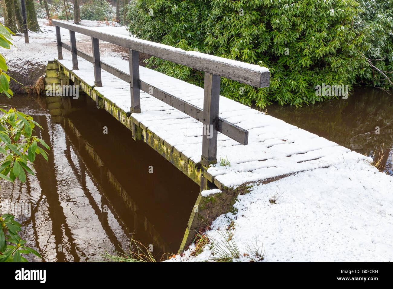 Wooden bridge covered with snow in winter Stock Photo