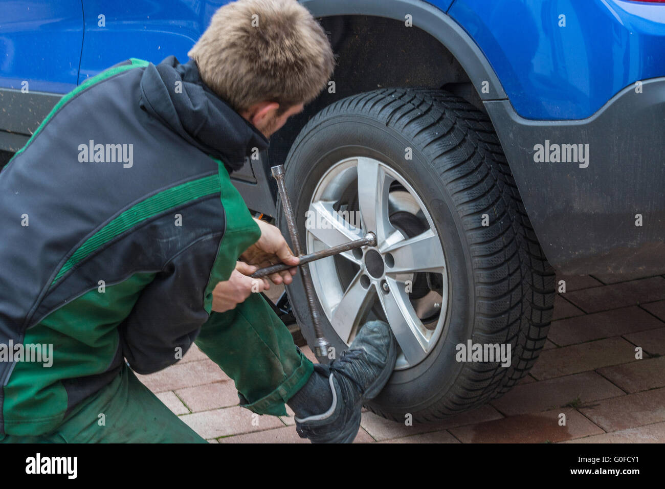 Replace summer tires against winter tires Stock Photo