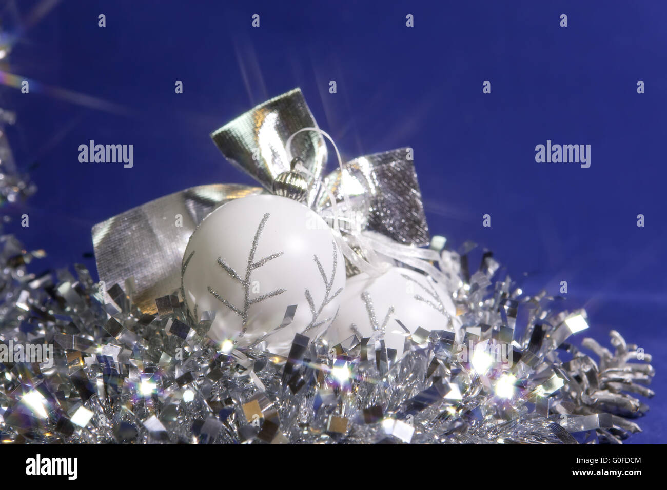 white New Year's balls and tinsel on a blue background Stock Photo
