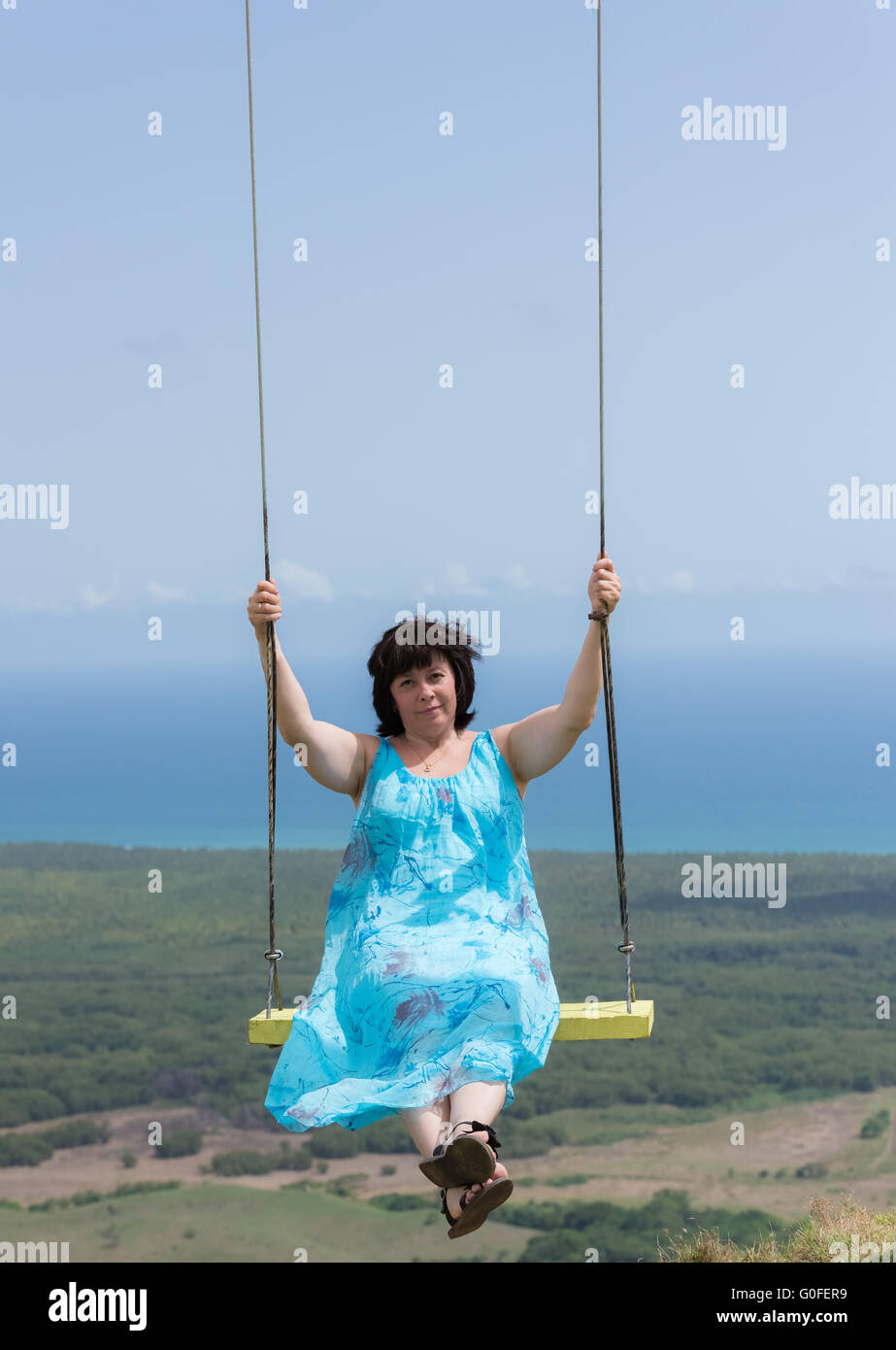 Woman on a swing Stock Photo - Alamy