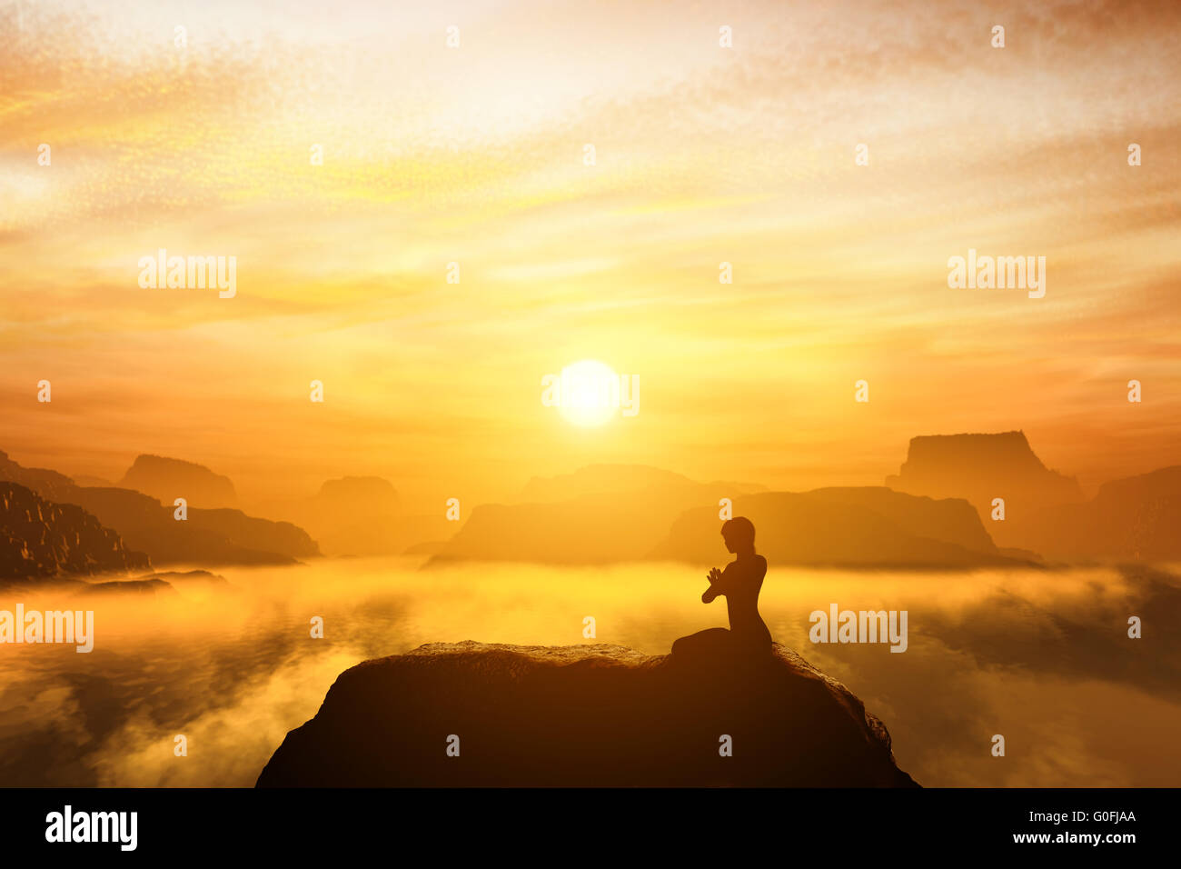 Woman meditating in sitting yoga position on the top of mountains above clouds at sunset. Zen Stock Photo