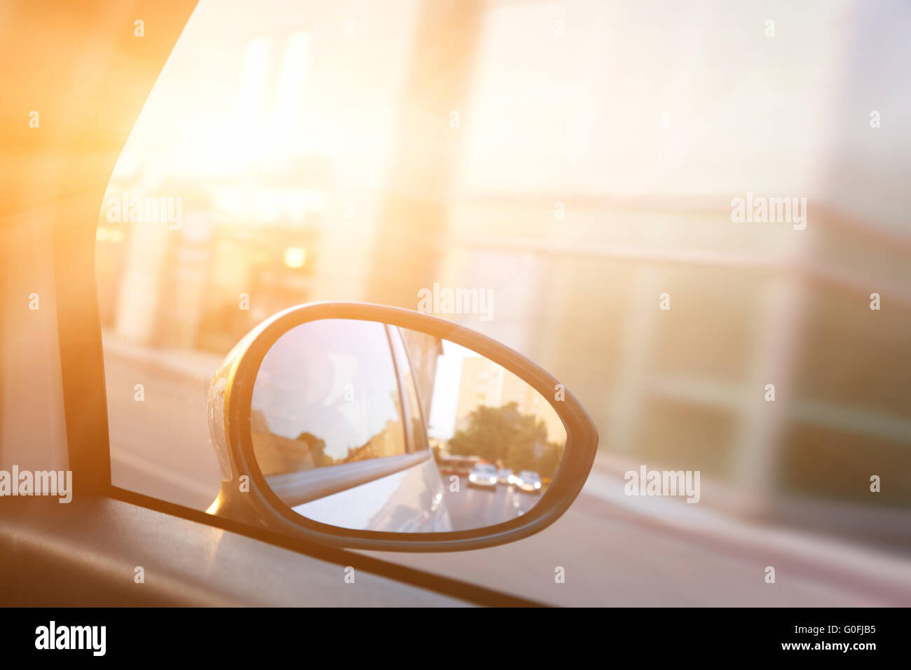 Dynamic view from car on the wing mirror during drive. Sun shining. Transportation Stock Photo