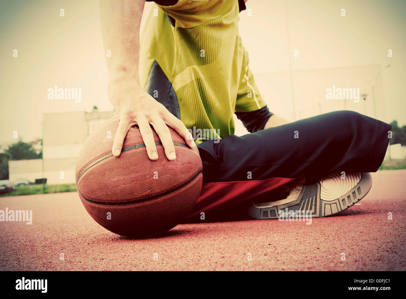 Boy sitting on basket ball hi-res stock photography and images - Alamy