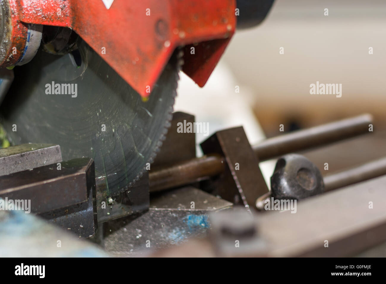 With a saw metal piece is cut Stock Photo
