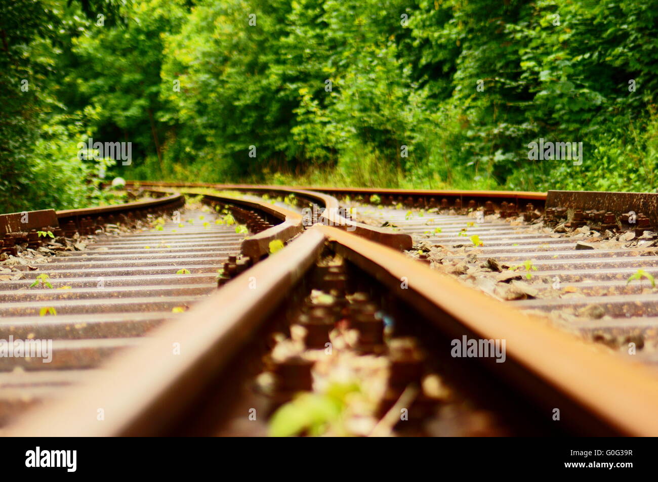 Flat angle via a switch in the train track with blur Stock Photo