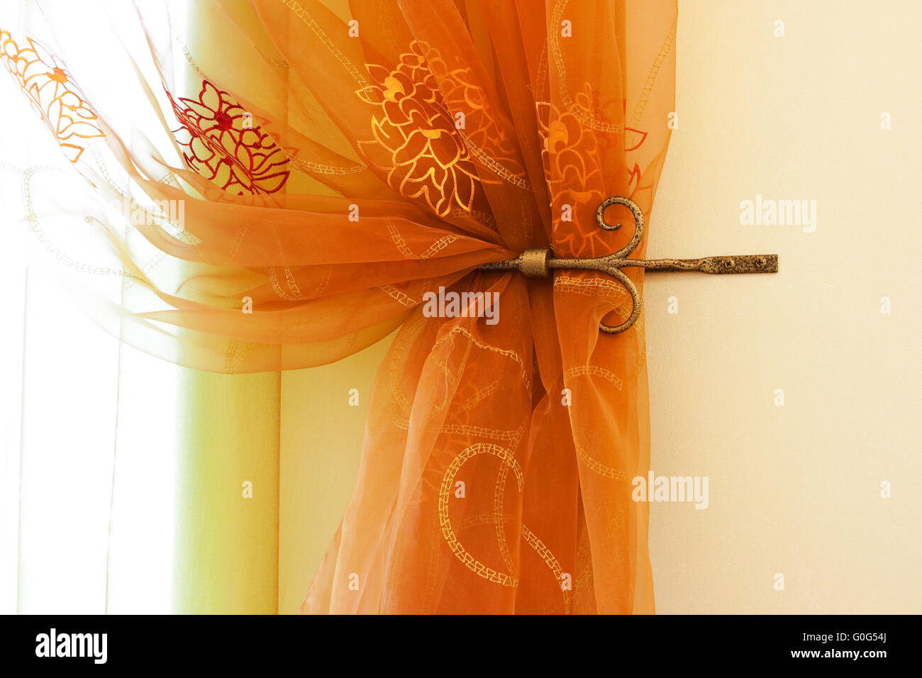 Beautiful translucent orange curtains in an apartment Stock Photo - Alamy