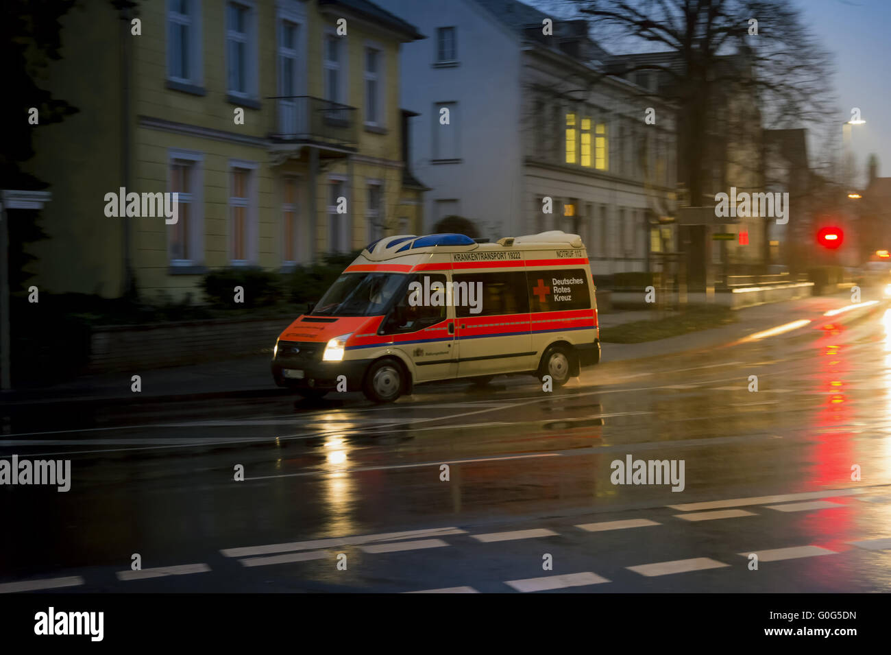 Ambulances, evening on a wet road. Stock Photo