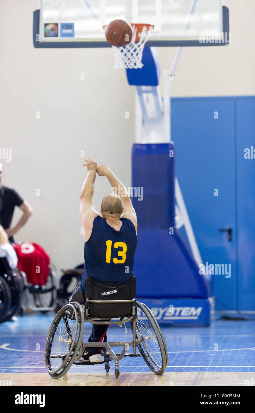 Basketball in wheelchairs for physically disabled players scoring Stock