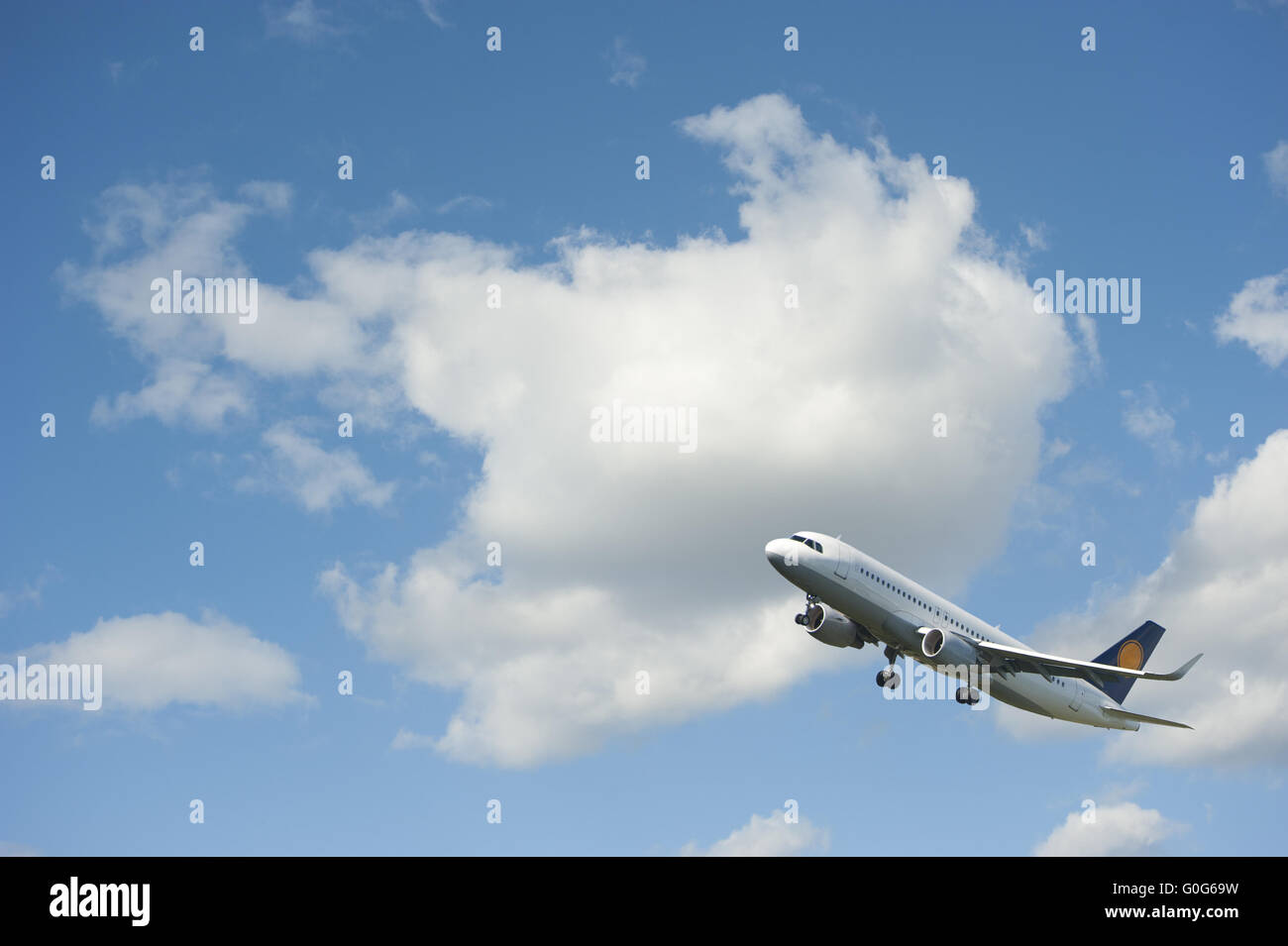 Plane takes off against the blue cloudy sky Stock Photo - Alamy