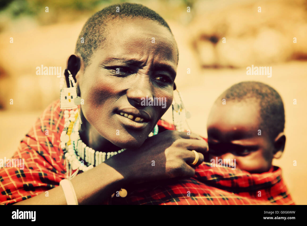 Maasai baby carried by his mother in Tanzania, Africa Stock Photo