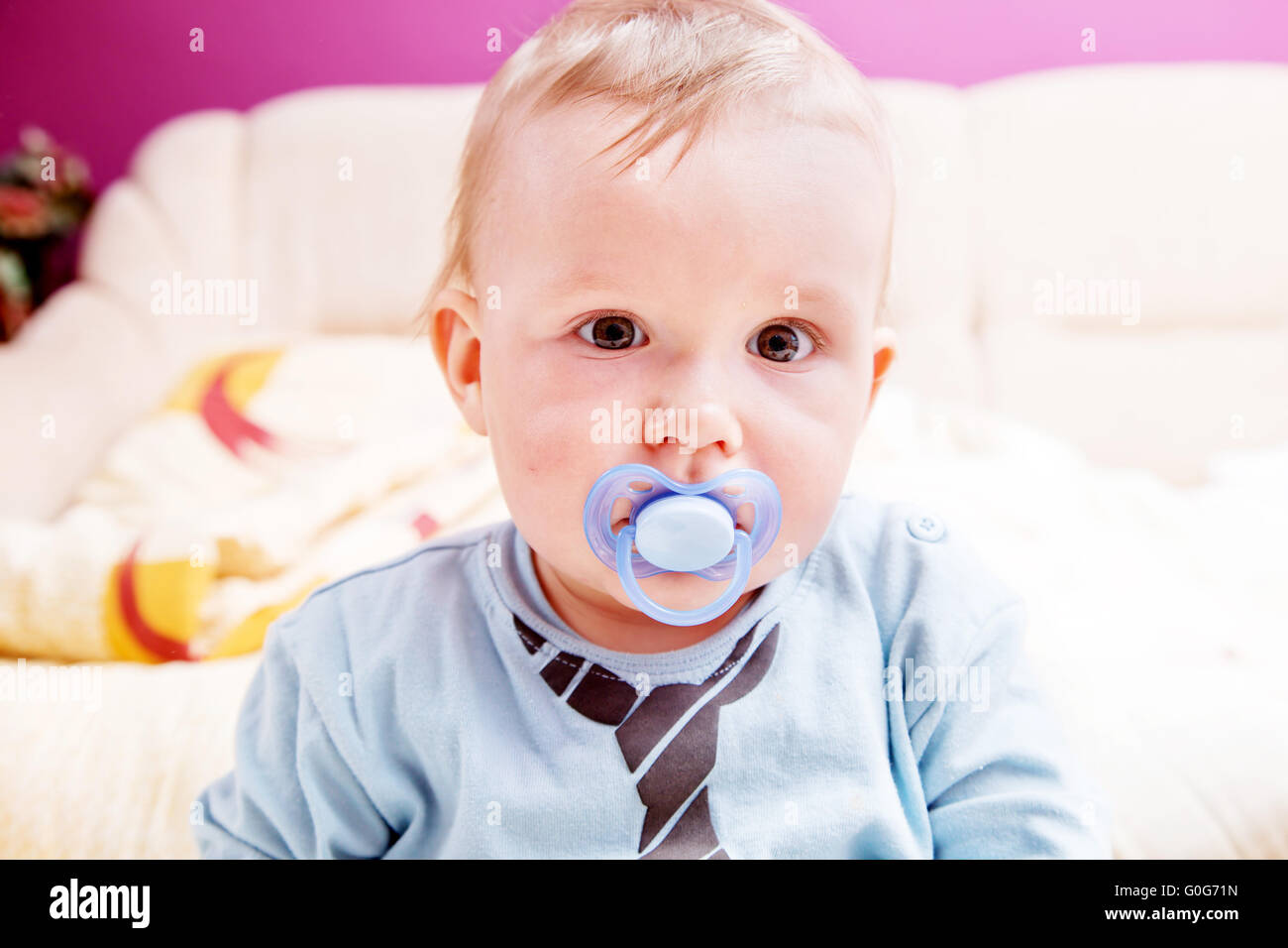 Young baby boy with a dummy in his mouth portrait Stock Photo Alamy