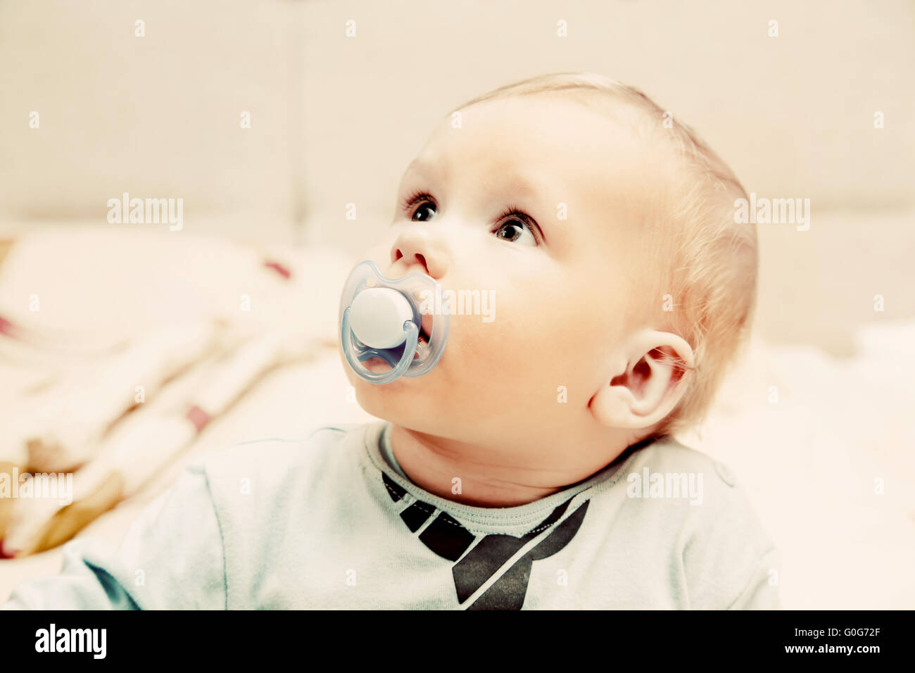 Young baby boy with a dummy in his mouth portrait Stock Photo Alamy