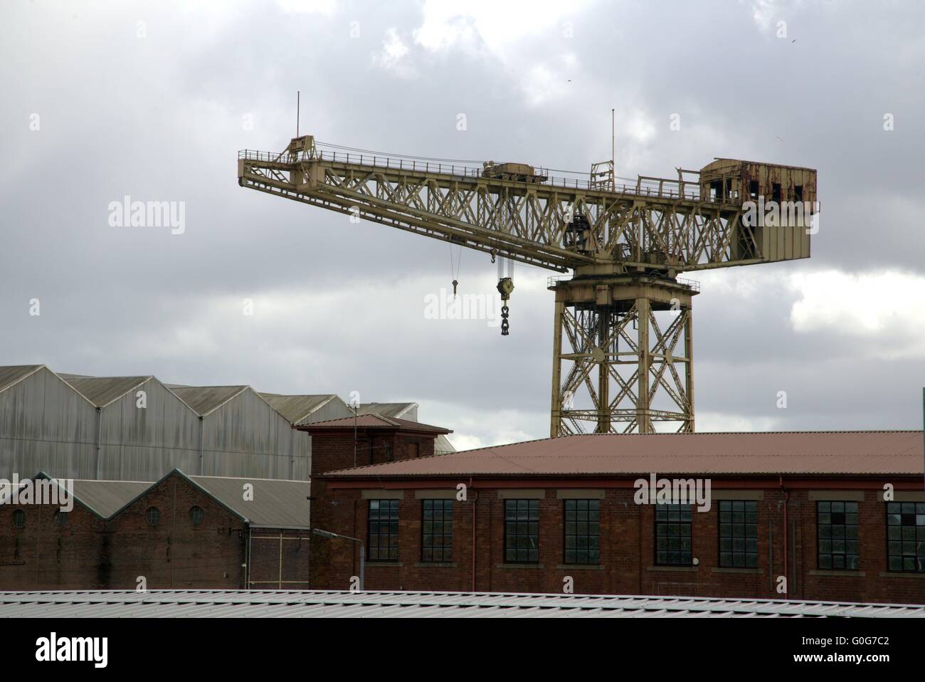 Clyde Titan Crane, Whiteinch Crane next to a junkyard, and itself next to a listed building of the former Diesel works Glasgow Stock Photo
